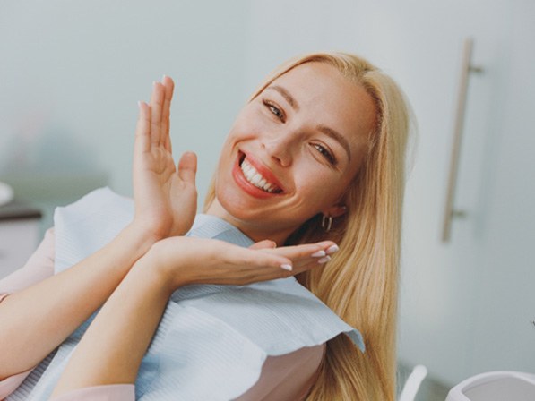 Blonde female dental patient leaning back and smiling