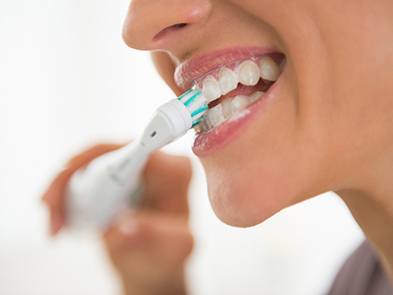 Closeup of a woman brushing her teeth