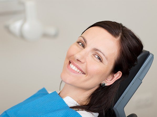 Womansmiling after biopsy of oral tissue procedure