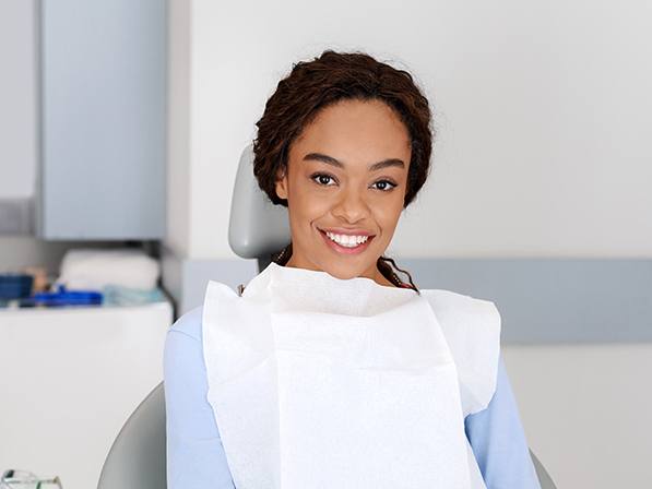 Woman smiling after tooth extraction procedure
