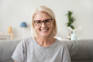 Older woman sitting on couch smiling