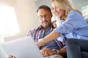 Couple sitting in front of computer, discussing dental insurance