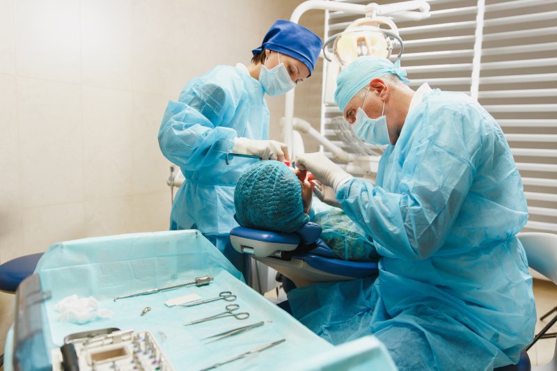 Dentists performing a guided dental implant surgery